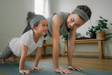 woman doing exercise with her daughter
