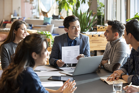 colleagues discussing, sitting at a table